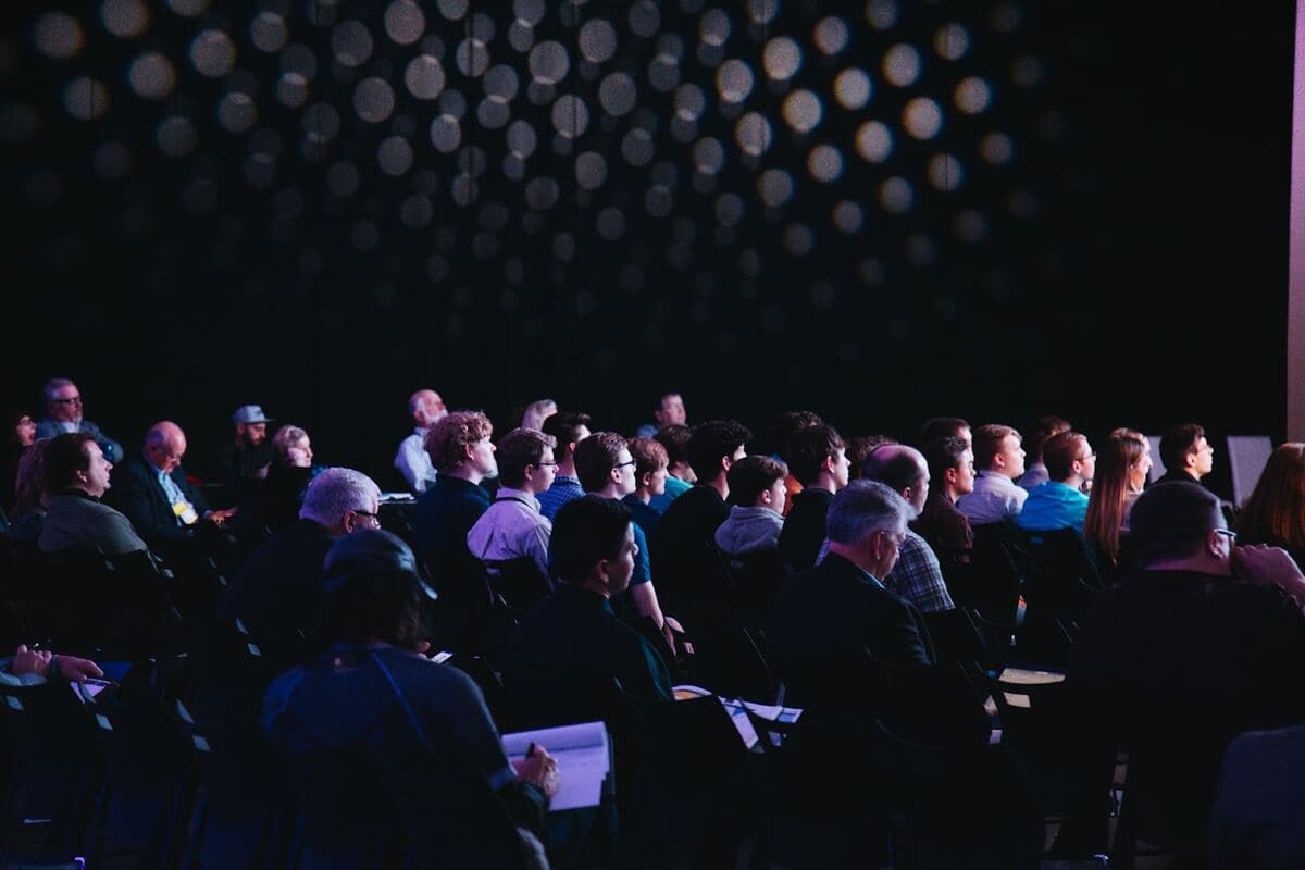 Large conference audience facing a stage